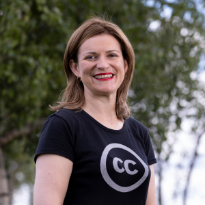Headshot of Catherine Stihler, wearing a black topw with a white CC logo with a tree in the background.