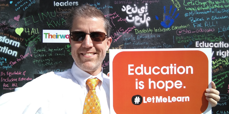 Cable Green holding a sign that says 