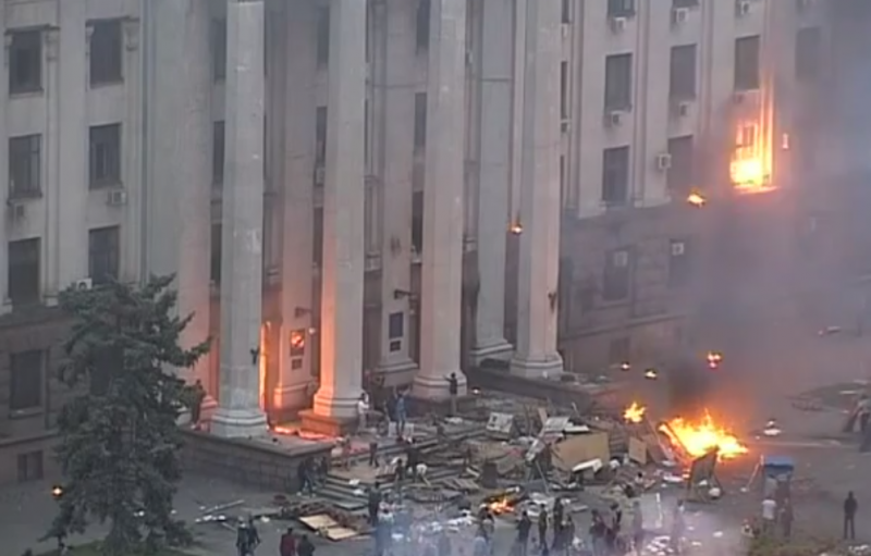 The besieged Odessa Union building. A Molotov cocktail explodes in the top right corner of the frame. Dozens died in the ensuing fire. YouTube screenshot.