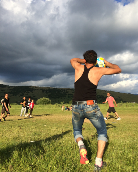 A refugee at Katsikas camp takes a throw-in in a game of football on a nearby field. Photo by author. 