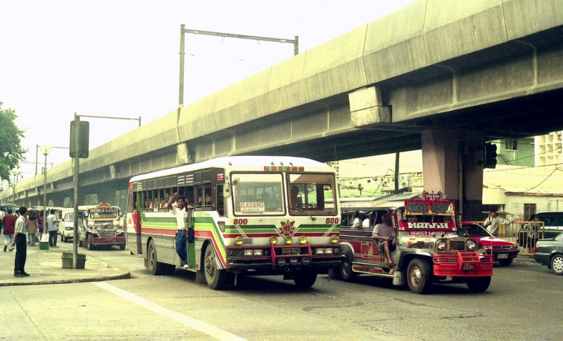 The main modes of transportation in Manila: Bus, Jeepney, LRT train. Flickr photo by John Ward (CC License)