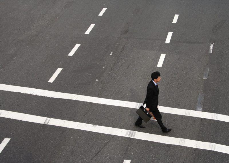 A salaryman crosses the street