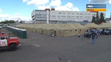 The detention center consists of tents on bare asphalt. YouTube screenshot.