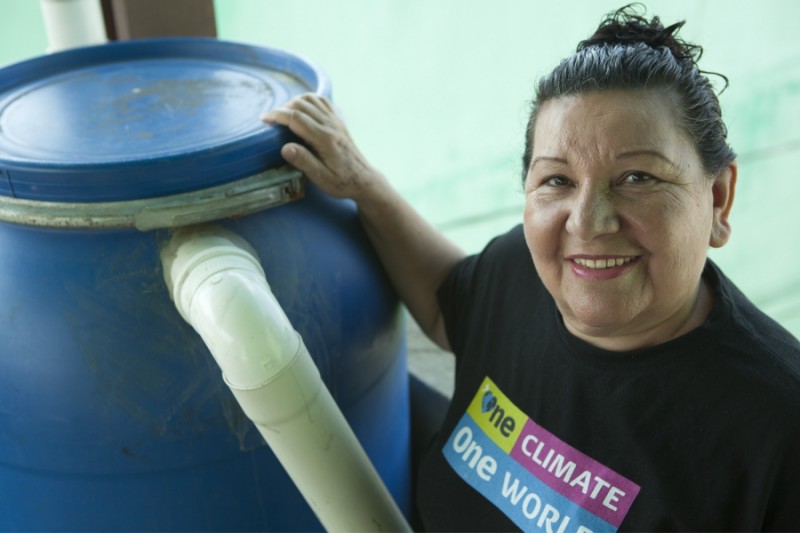 Terezinha da Silva with one of the her signature rain barrels. Credit: Anne Bailey. Used with PRI's permission