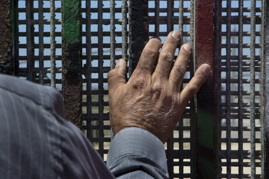Pastor Guillermo Navarrete of the Methodist Church of Mexico stands at the border fence at Friendship Park during the weekly meeting of the Border Church in Tijuana, Mexico, on May 22, 2017. The binational service is conducted simultaneously on both sides of the border fence in English and Spanish. Photo by Griselda San Martin. Used with permission.