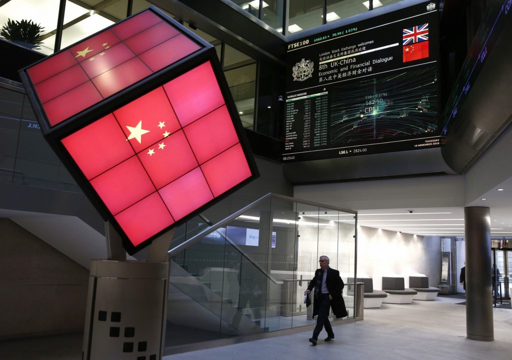 An illuminated cube bearing the Chinese flag is seen in the entrance foyer of the London Stock Exchange in London